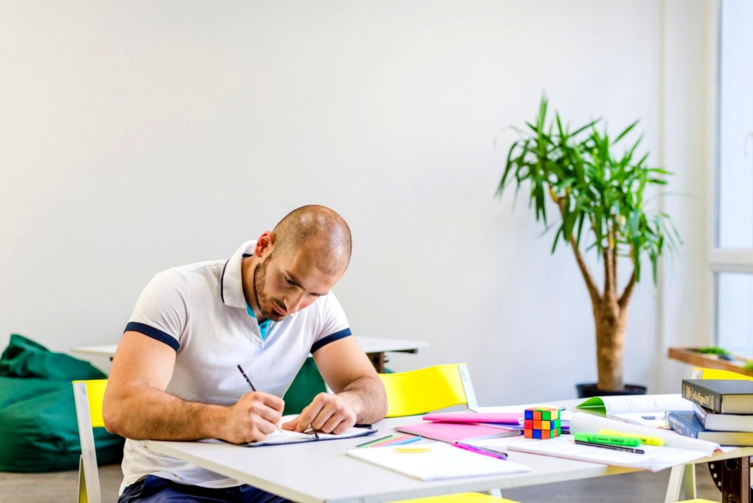 Modern office environment showing database administrators working collaboratively on workstations with multiple monitors
